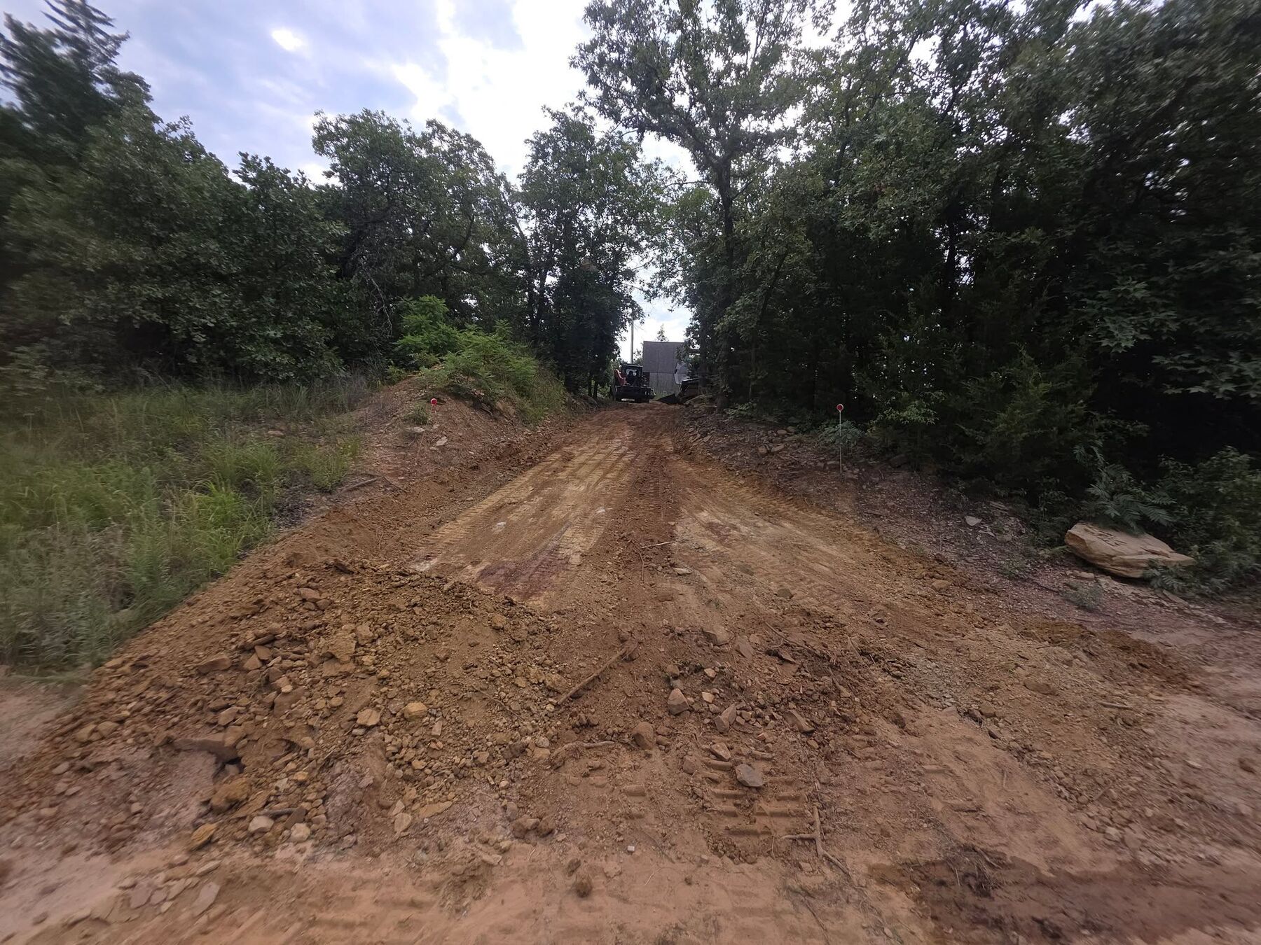 Fresh red dirt built up into a raised driveway pad