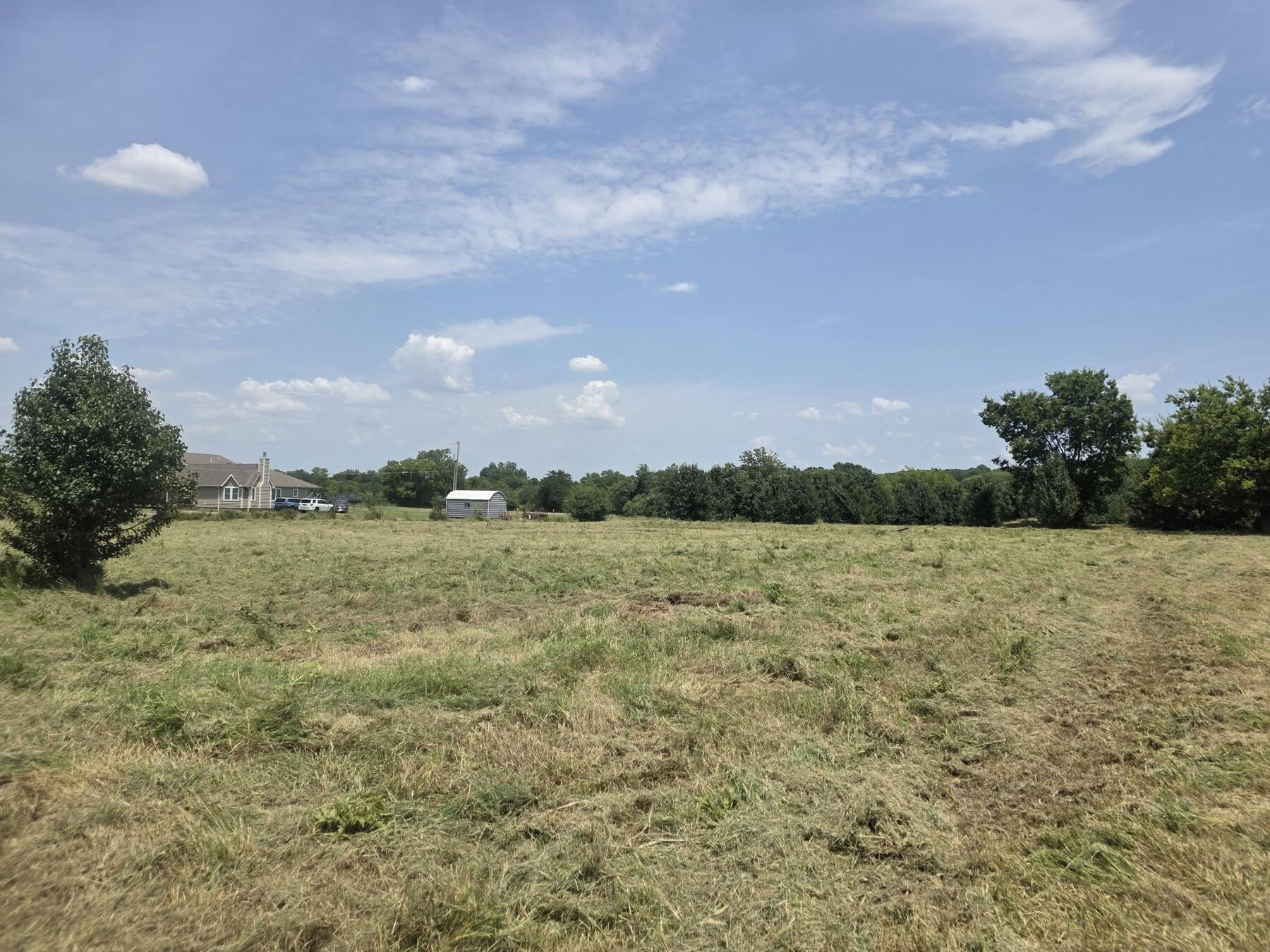 Wide field mowed down with clean cut lines after brush hogging