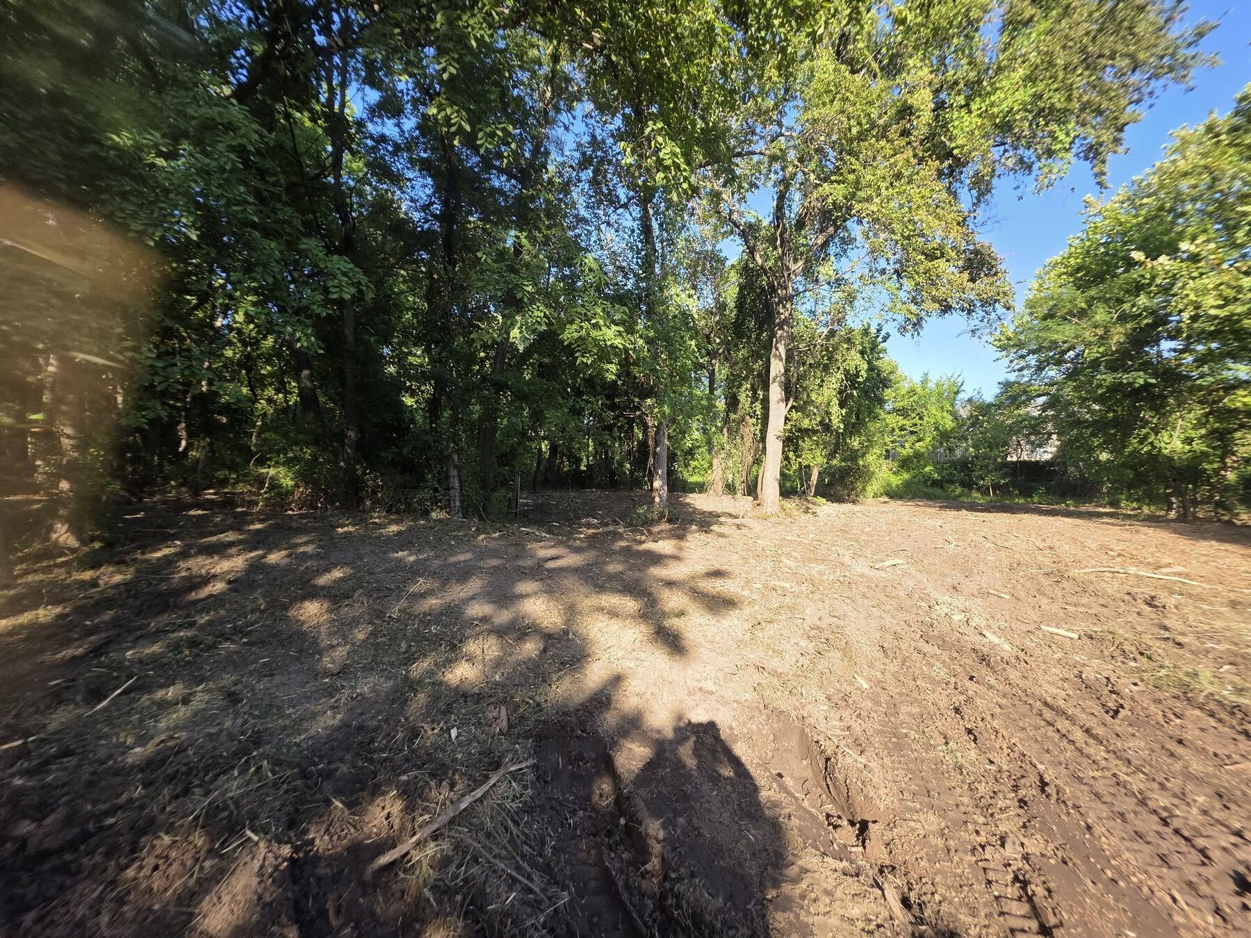 Graded dirt building pad opened up in a cleared tree line