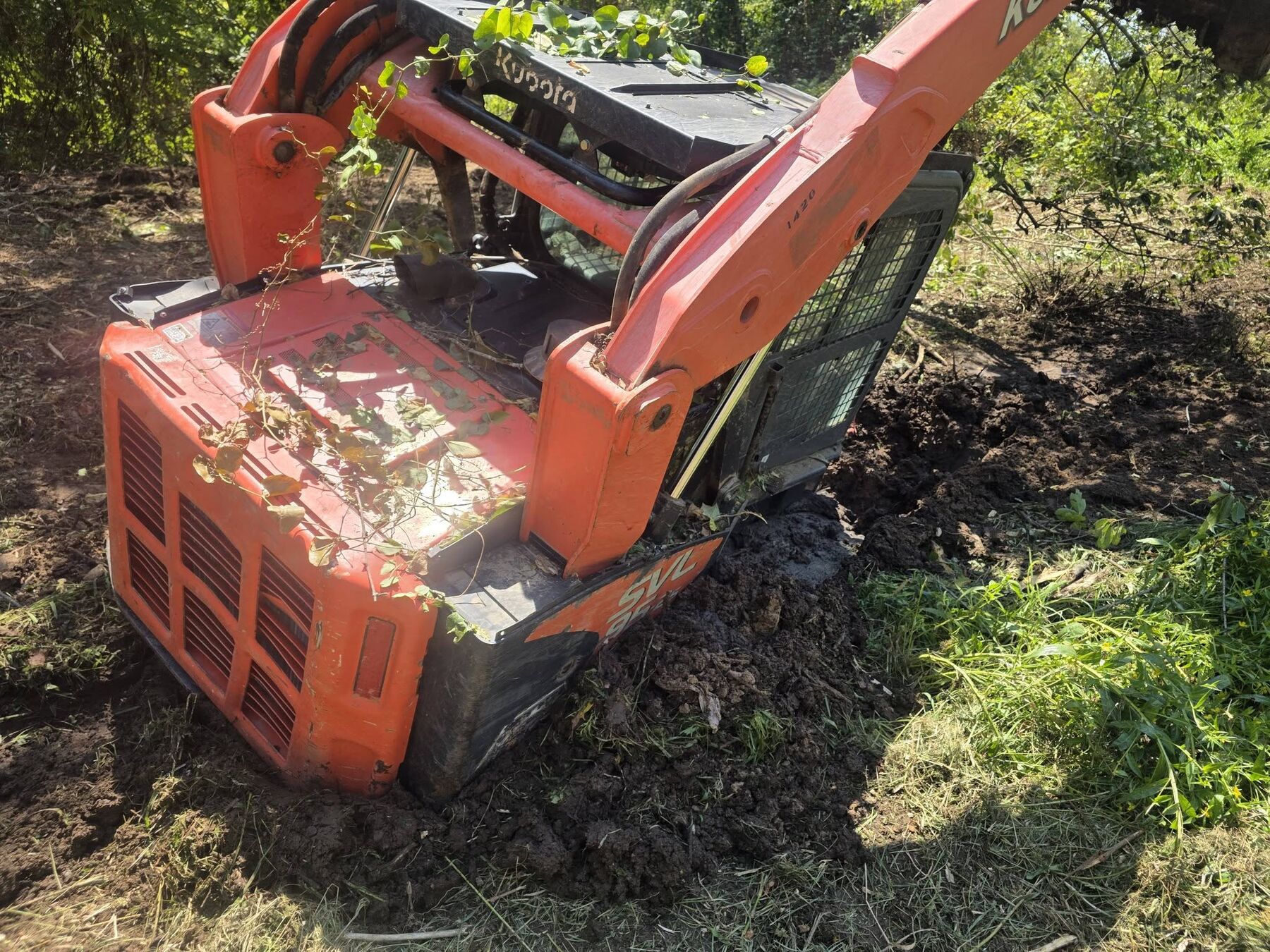 Kubota track loader working wet ground during land clearing